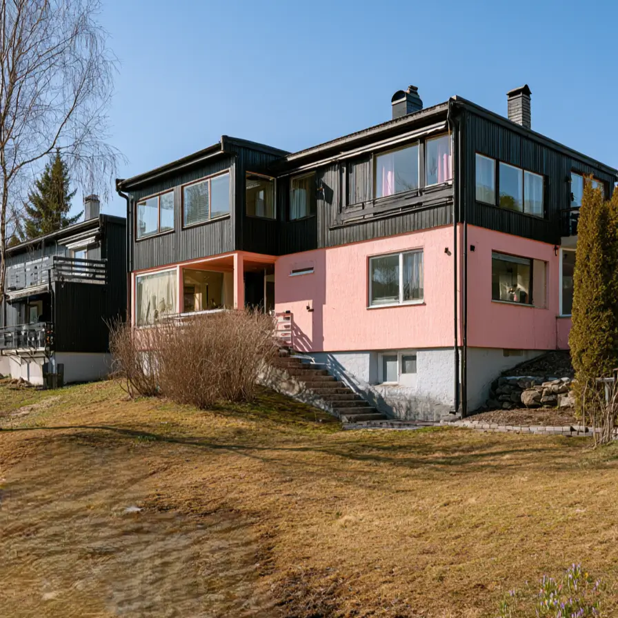 26 Black and Pink Houses Worth Saving Before You Paint 6 Scandinavian hillside house with a pink stucco base and black timber upper story over a white foundation